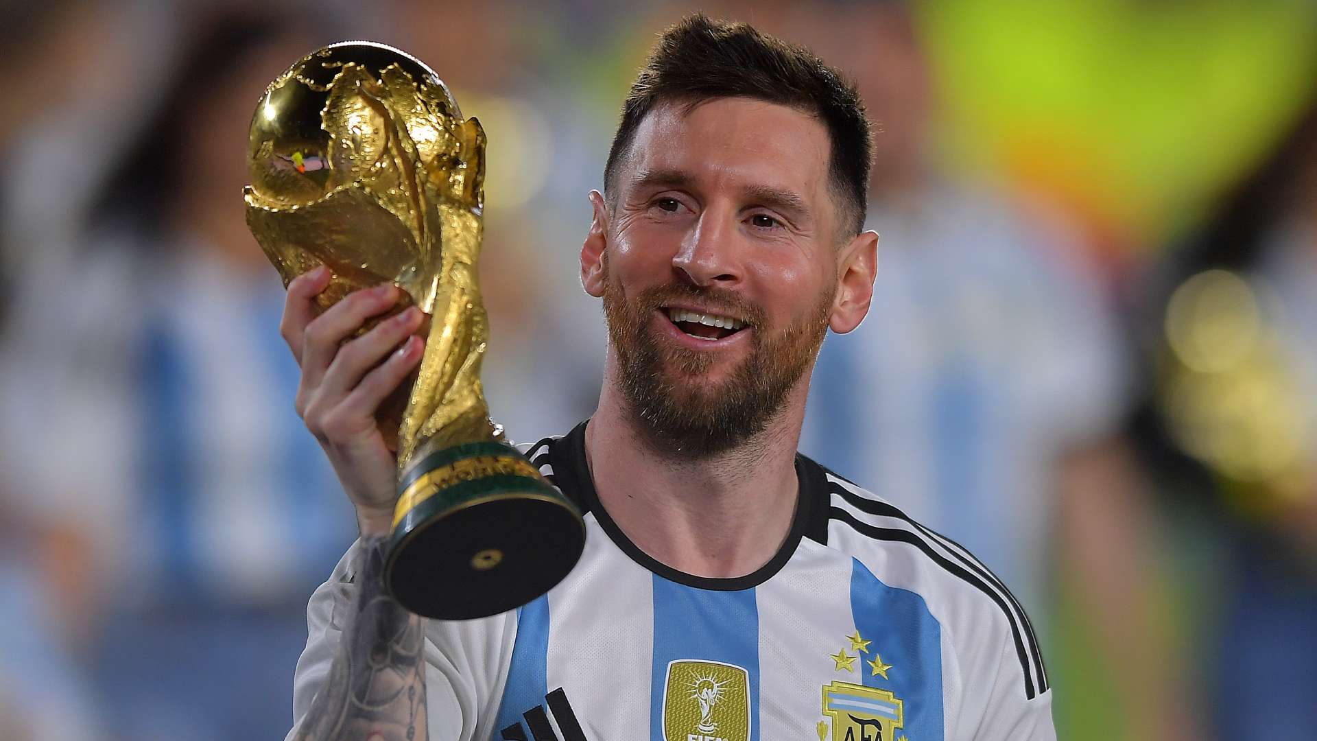 Lionel Messi holding the FIFA World Cup trophy after Argentina's 2022 victory