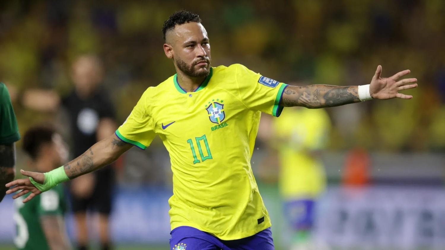 Neymar celebrating in Brazil's yellow number 10 shirt with arms outstretched